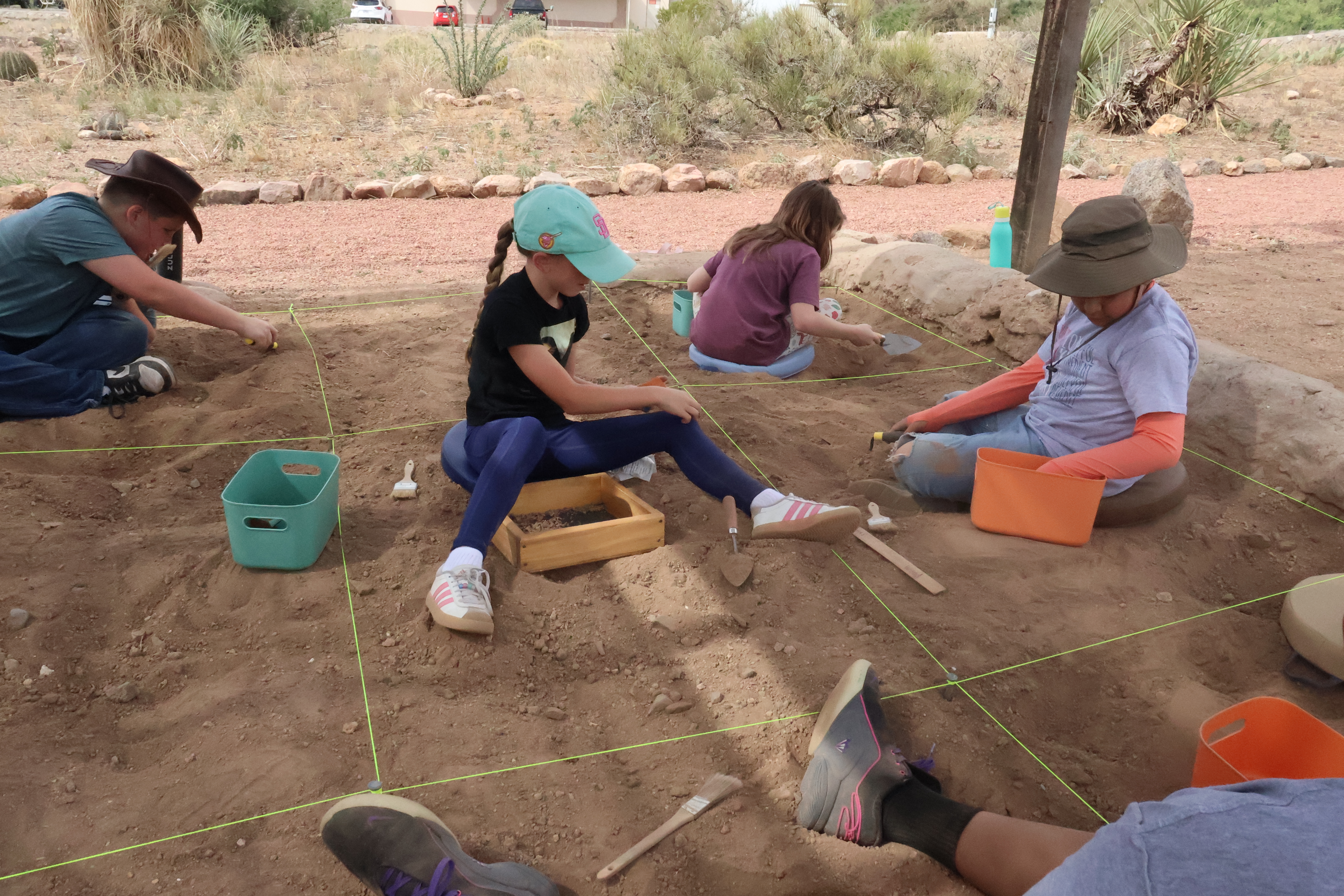 Young archaeologists are working in the mock dig.