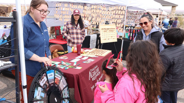 Vendor talking to little girl and mother.